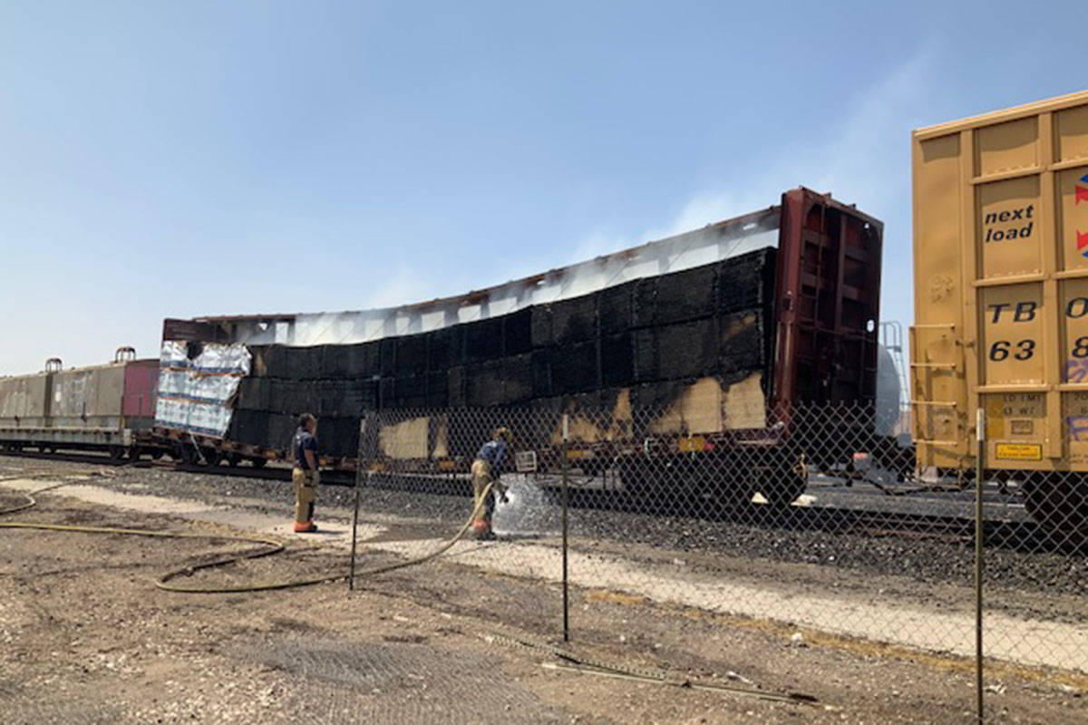 Crews battle a flatbed rail car Sunday, Aug. 8, 2021, at 926 S. Commerce St. in Las Vegas. (La ...