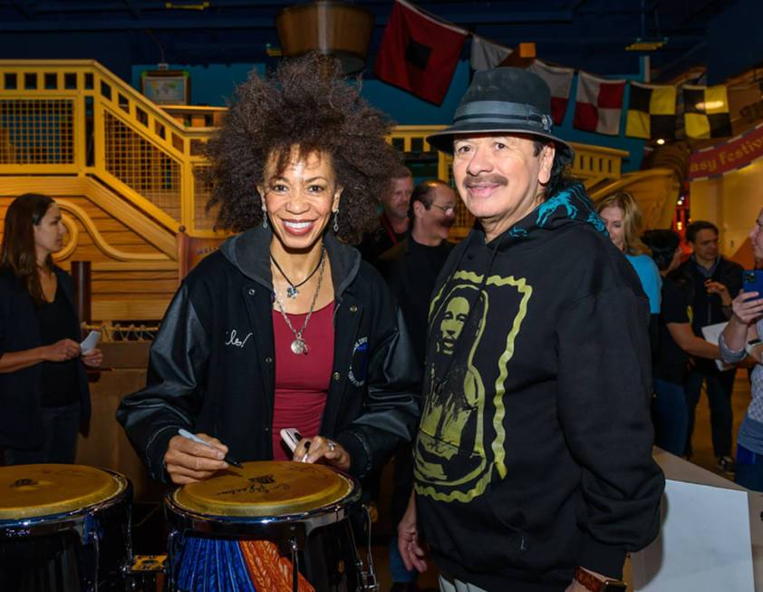 Carlos Santana and Cindy Blackman Santana, shown signing a bongo drum, appear at a Discovery Ch ...