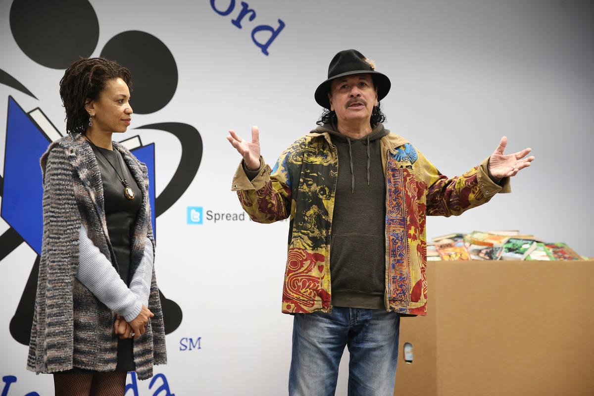 Carlos Santana, right, with his wife Cindy Blackman Santana, speak during a visit to the Spread ...