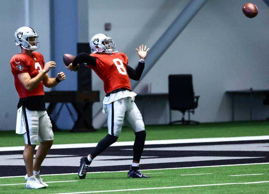 Raiders quarterback Marcus Mariota (8) looks to throw a pass alongside quarterback Nathan Peter ...