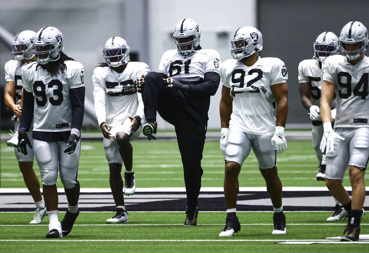 Raiders defensive tackle Gerald McCoy (61) warms up alongside teammates during training camp at ...