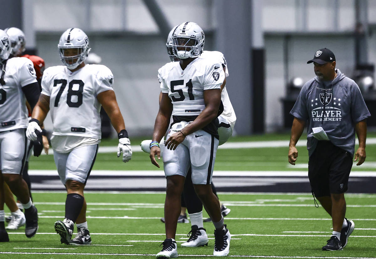 Raiders defensive end Malcolm Koonce (51) warms up alongside teammates during training camp at ...