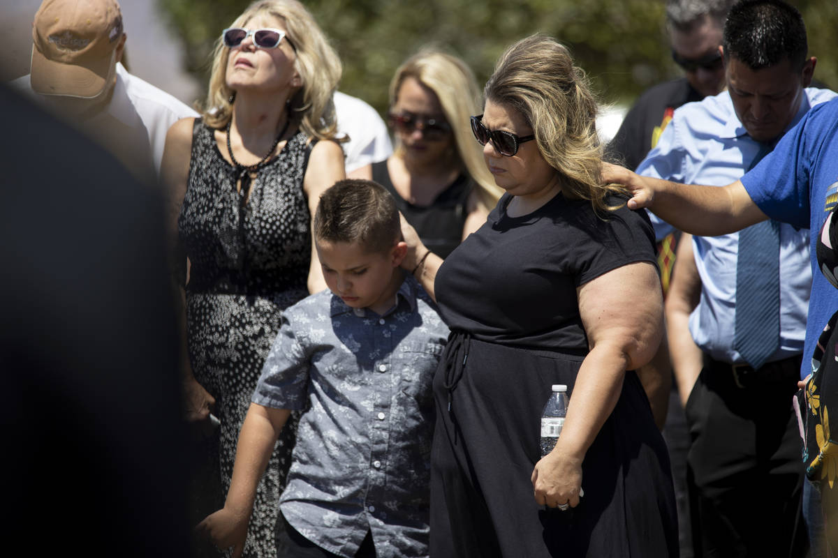 In this July 8, 2021, Christa Swanger, right, and her son Noah, 8, attend the funeral service f ...
