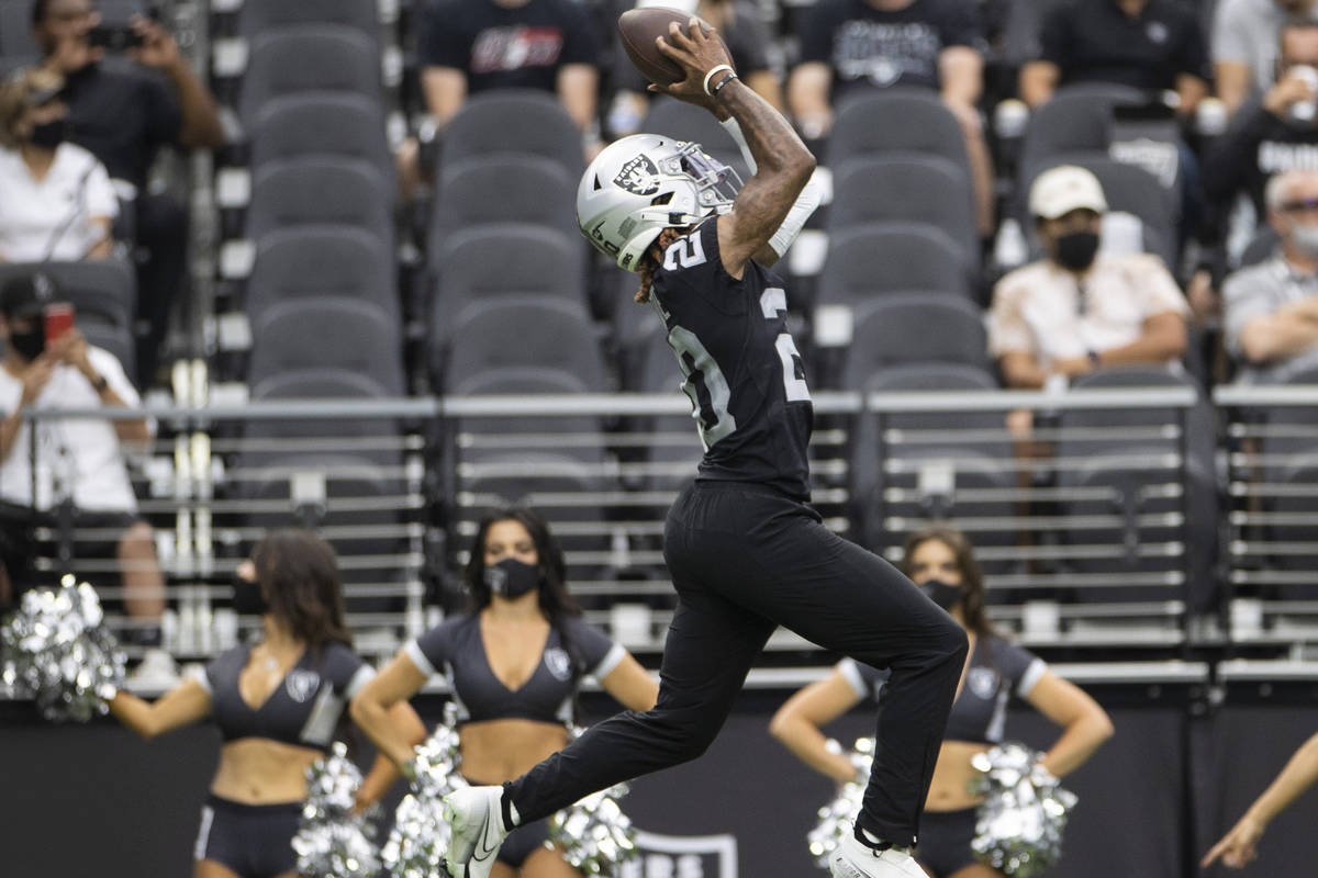Raiders cornerback Damon Arnette (20) makes a leaping catch during a special training camp prac ...