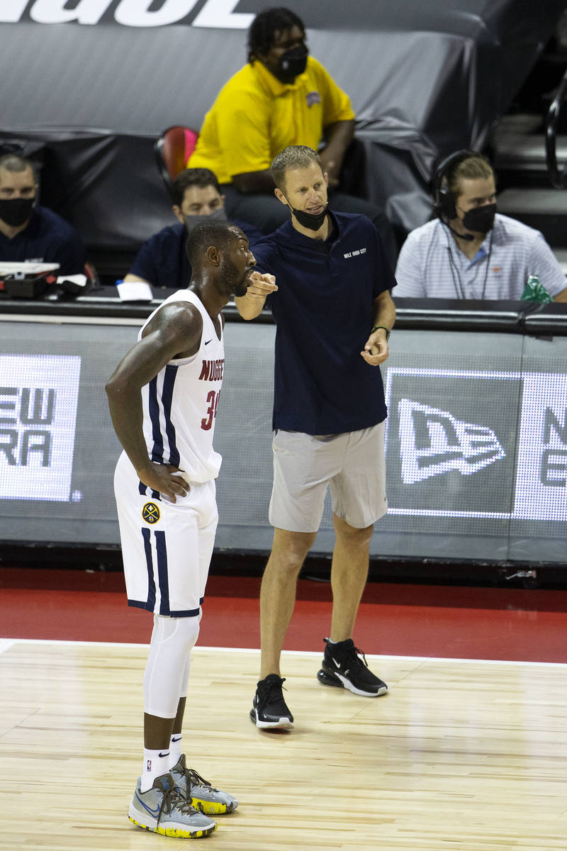 Denver Nuggets head coach Charles Klask communicates with forward Davon Reed (34) during the se ...