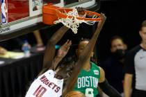 Denver Nuggets center Bol Bol (10) dunks as Boston Celtics guard Romeo Langford (10) jumps to b ...