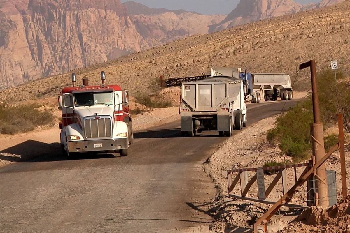Trucks make their way up and down the road to Blue Diamond Hill Gypsum Mine near Red Rock Canyo ...