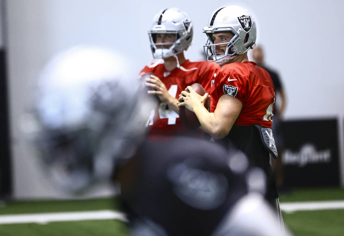 Raiders quarterback Derek Carr looks to throw a pass during training camp at Raiders Headquarte ...