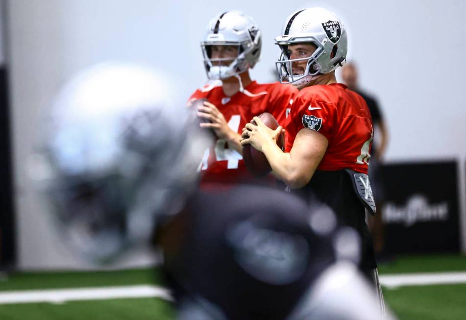 Raiders quarterback Derek Carr looks to throw a pass during training camp at Raiders Headquarte ...