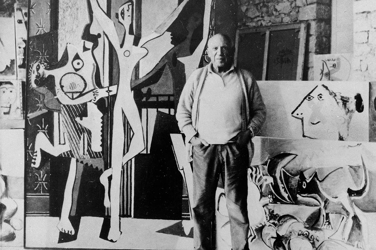 Artist Pablo Picasso poses in 1965 in front of one of his favorite paintings, "Les Trois Danseu ...