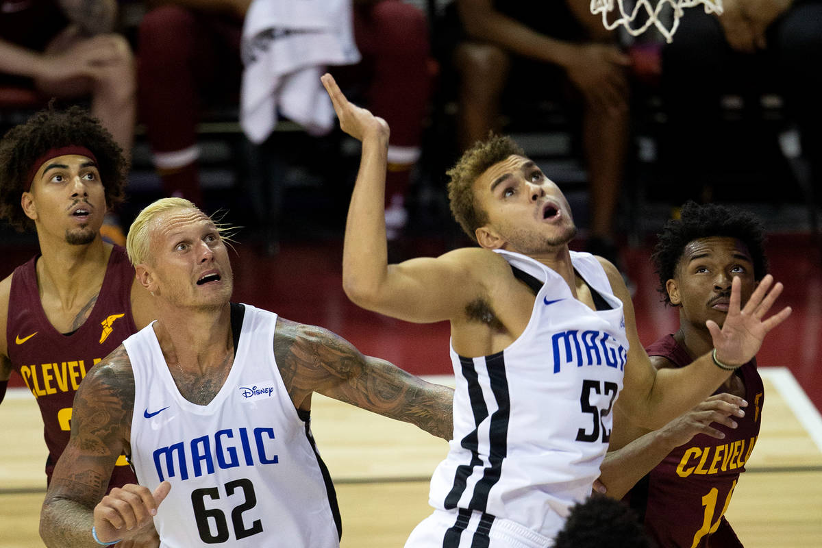Orlando Magic forward Janis Timma (62) and forward D.J. Hogg (52) watch to see if their point w ...