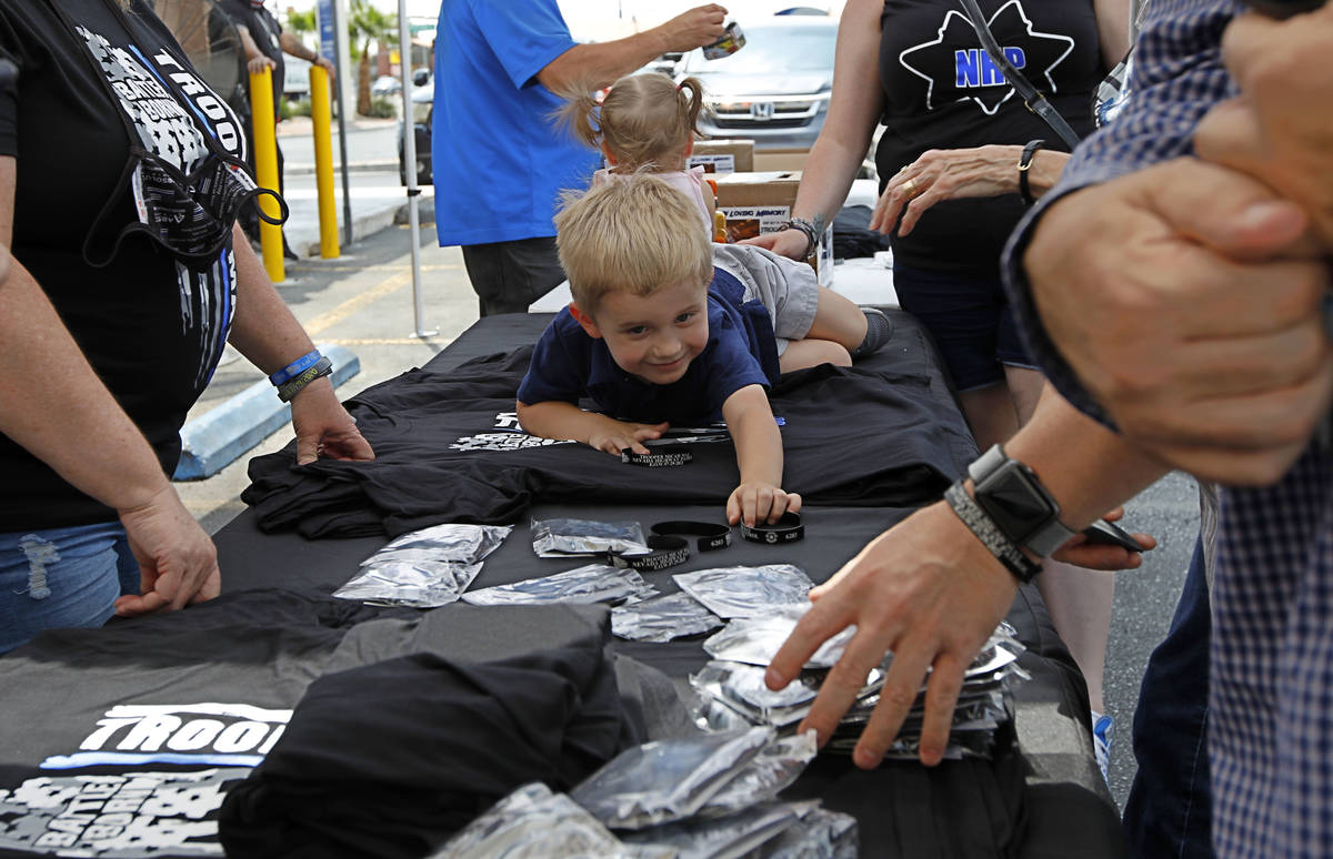 Slain Nevada Highway Patrol trooper Micah May's son Raylan, 3, checks the items during a fundra ...