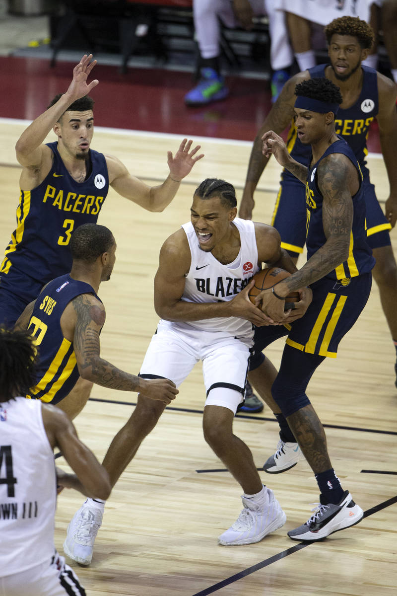 Portland Trail Blazers forward George King (8) fights for the ball surrounded by Indiana Pacers ...