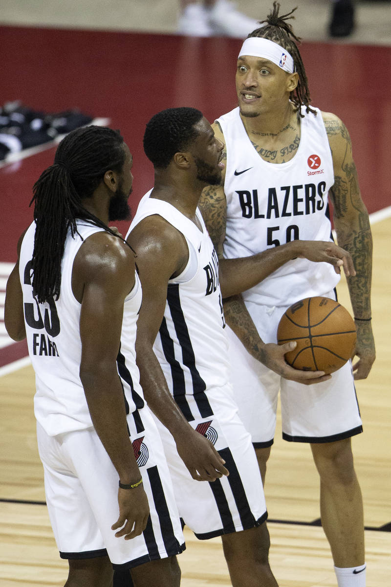 Portland Trail Blazers forward Michael Beasley (50) reacts to a referee's call next to his team ...