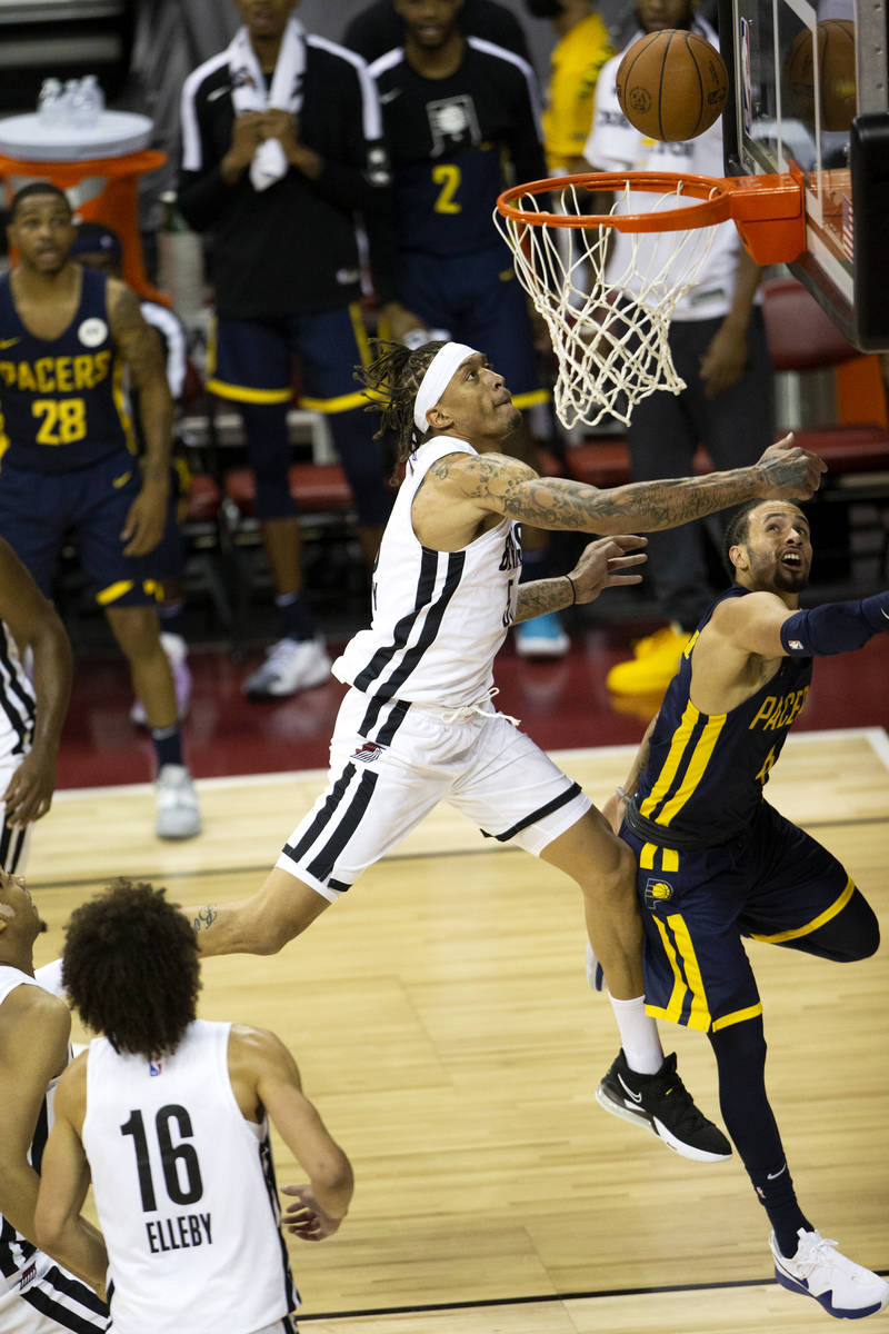 Portland Trail Blazers forward Michael Beasley (50) jumps for a layup next to Indiana Pacers gu ...