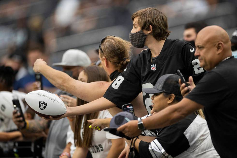 Raider fans take in the action during a special training camp practice for season ticket holder ...