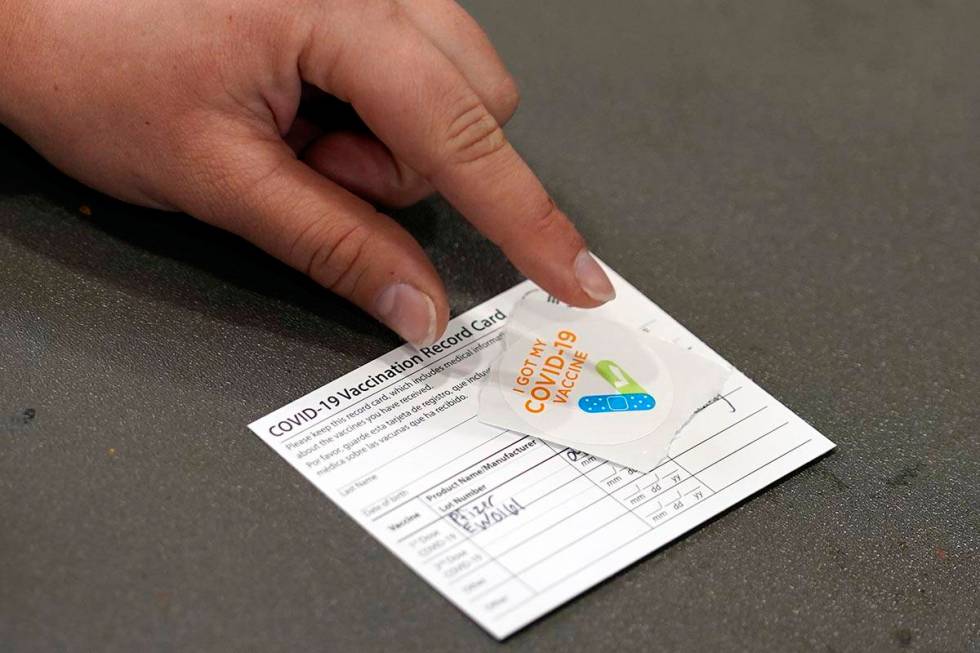 A COVID-19 vaccination card is displayed at the Banning Recreation Center in Wilmington, Calif. ...
