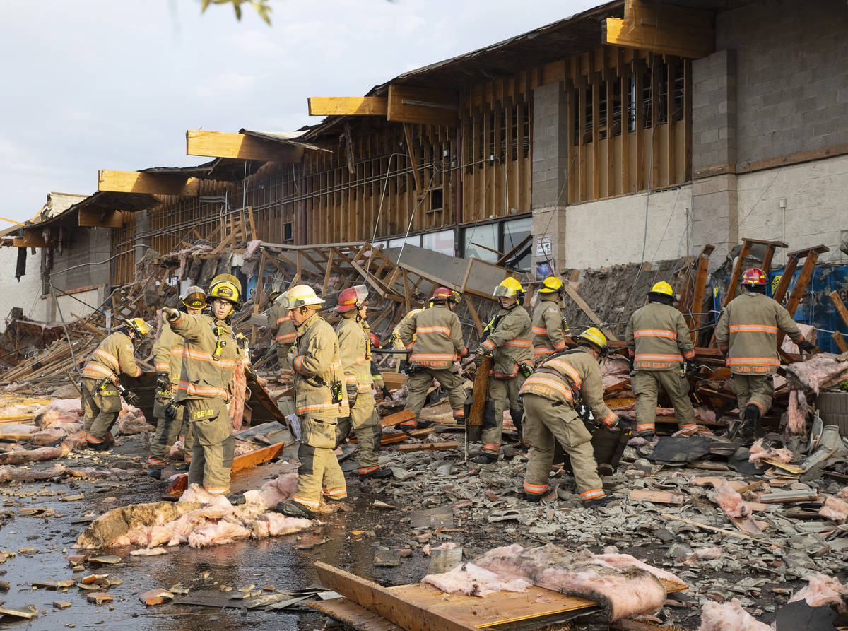 The Clark County firefighters work throw debris after a portion of La Bonita supermarket collap ...