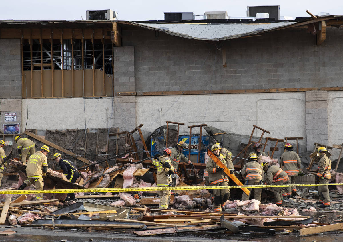The Clark County firefighters work throw debris after a portion of La Bonita supermarket collap ...