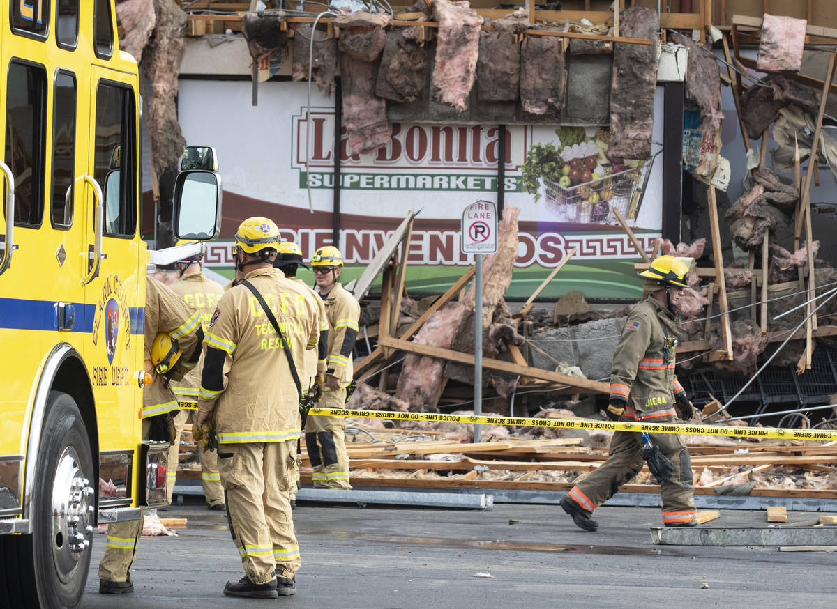The Clark County firefighters work through debris after a portion of La Bonita supermarket coll ...