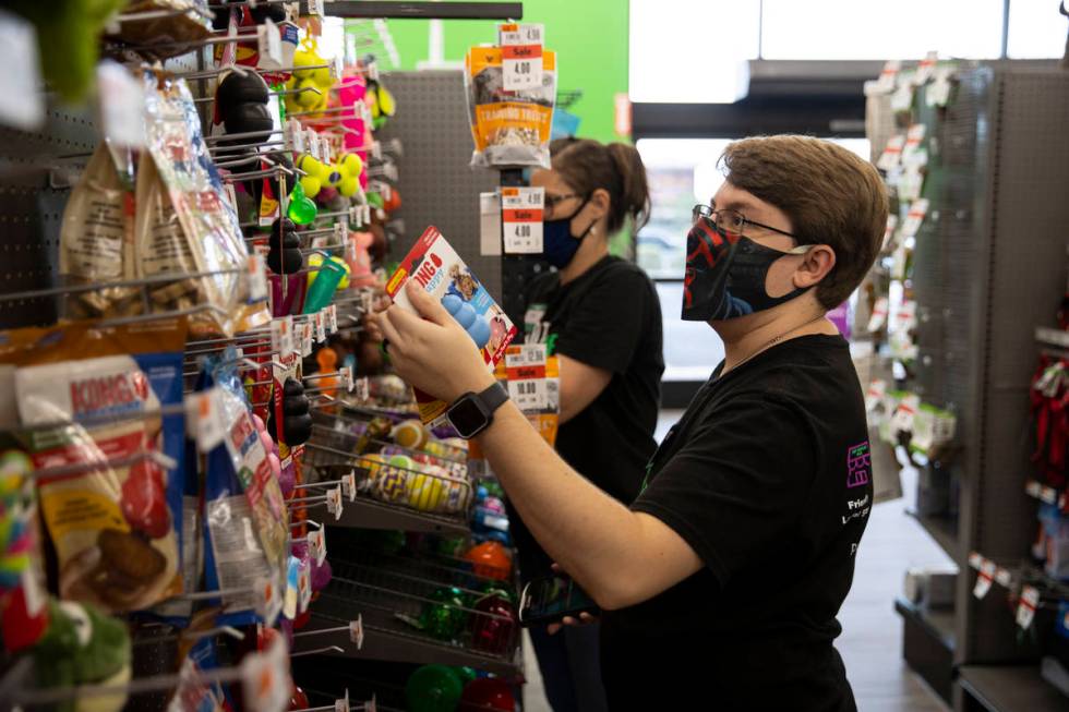 Shift leader Jeff Redfern rearranges items at Pet Supplies Plus, owned by local entrepreneur an ...