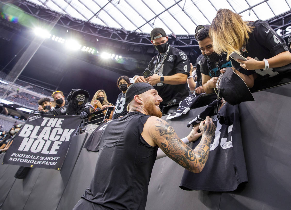 Raiders defensive end Maxx Crosby (98) signs autographs for fans before the Raiders home openin ...