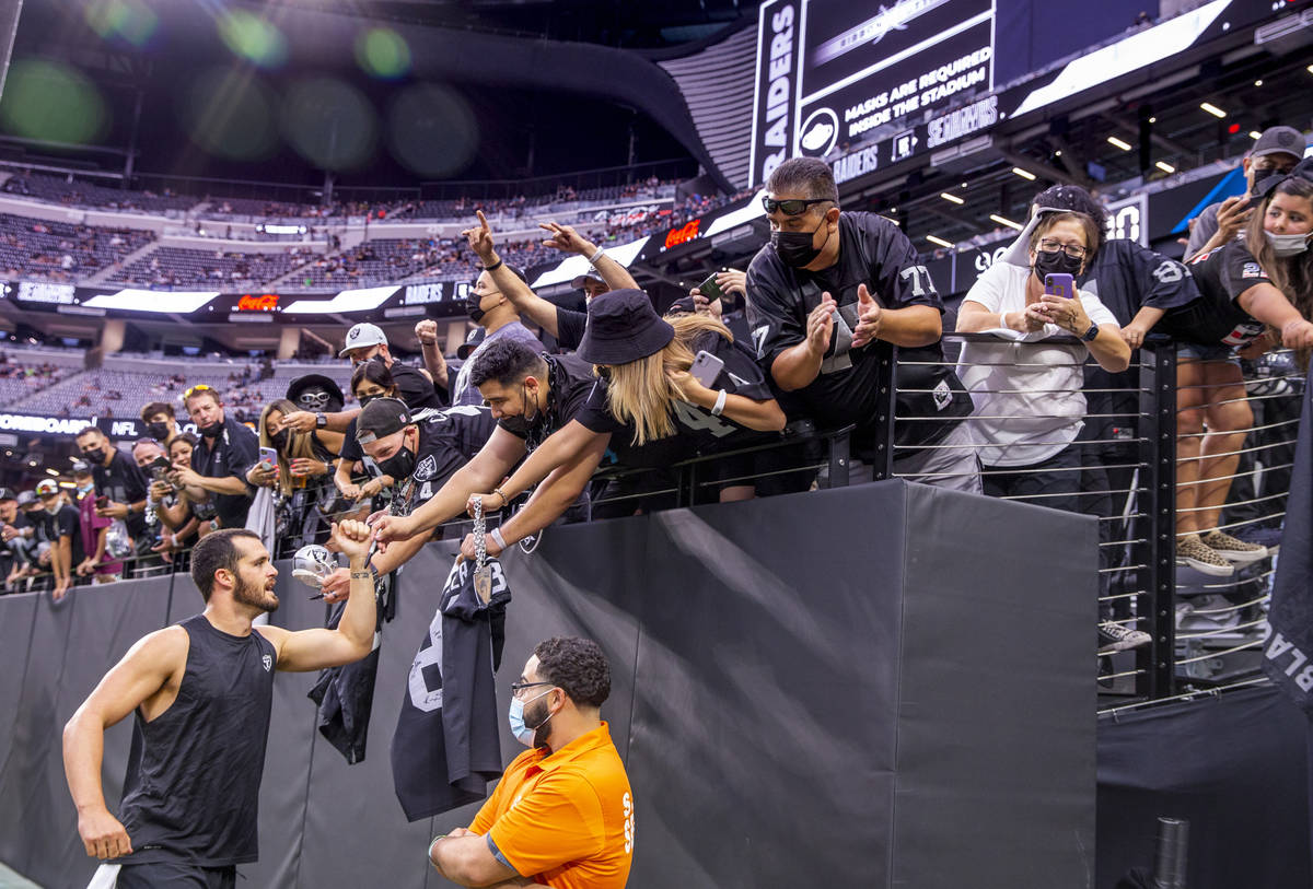 Raiders quarterback Derek Carr (4) greets fans on the field before the Raiders home opening pre ...