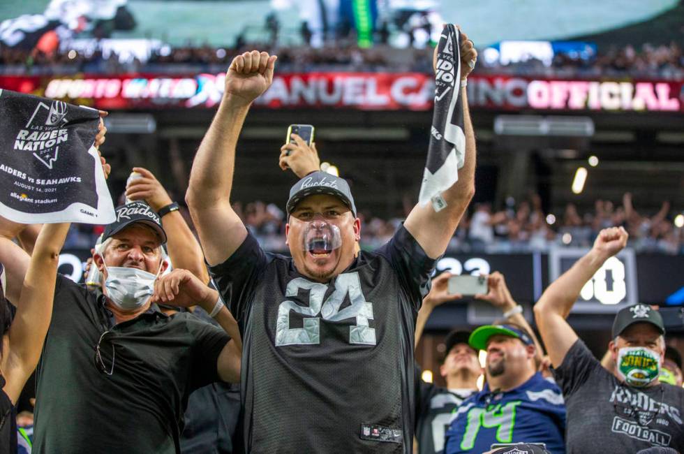 Raiders fans celebrate the first touchdown of the game during the first quarter of the Raiders ...