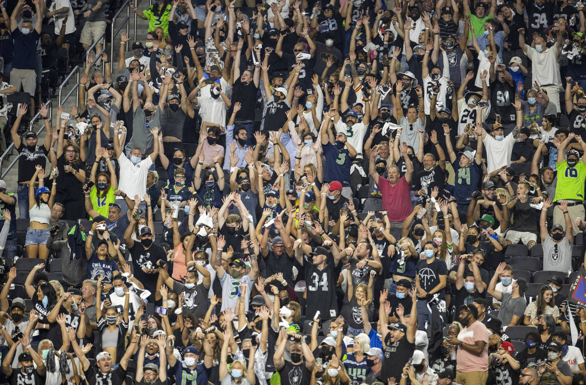 Fans do Òthe waveÓ during the third quarter of the Raiders home opening pre-season NF ...