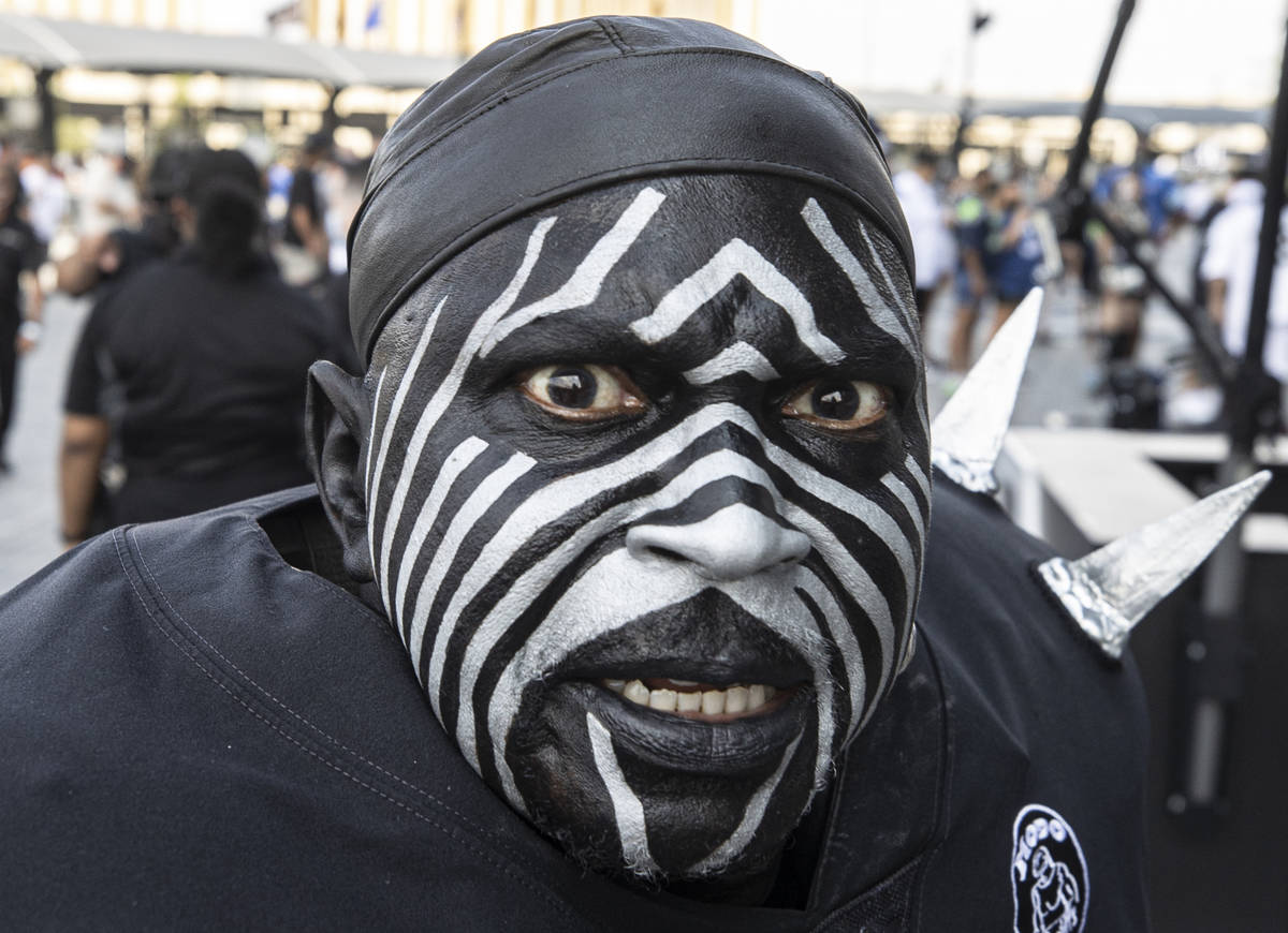 Raiders super fan “Violator” makes his way to Allegiant Stadium before the start ...