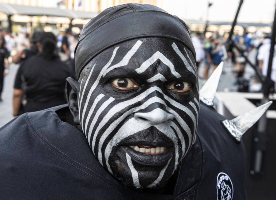 Raiders super fan “Violator” makes his way to Allegiant Stadium before the start ...