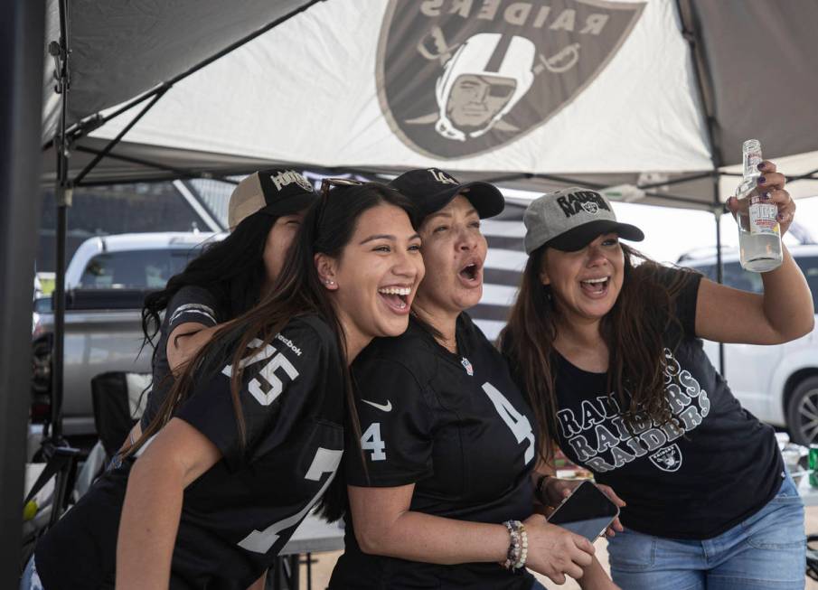 Raiders fans Isabella Luna, left, Carmen Tellez and Lisette Dominguez tailgate outside Allegian ...