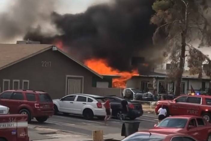 A fire engulfs a house in the 2200 block of North Bassler Street in North Las Vegas on Friday, ...