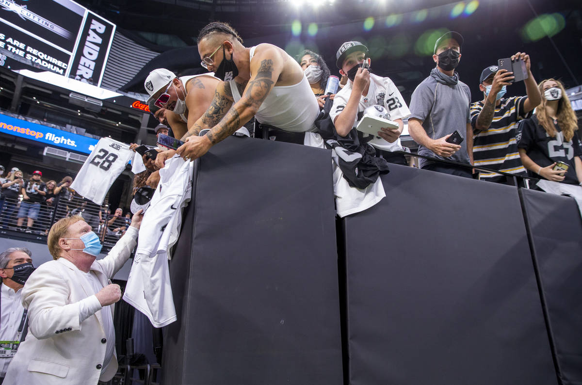 Raiders owner Mark Davis signs autographs for fans before the Raiders home opening pre-season N ...