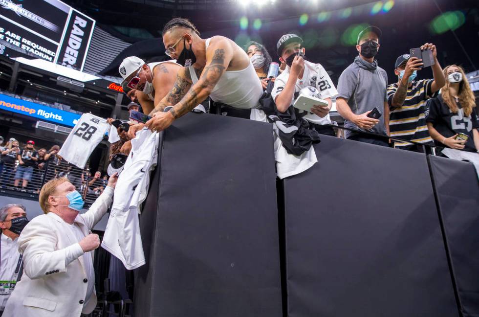 Raiders owner Mark Davis signs autographs for fans before the Raiders home opening pre-season N ...