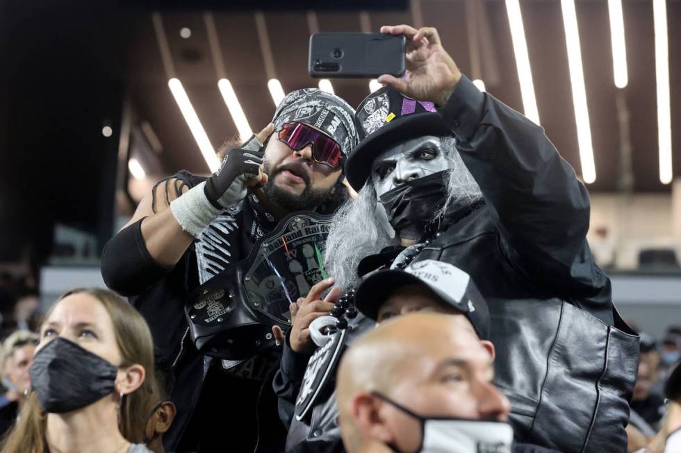 Oakland Raider Savage, left, and Sammy "Raider Penguin" Alonzo of Albuquerque, N.M., during the ...