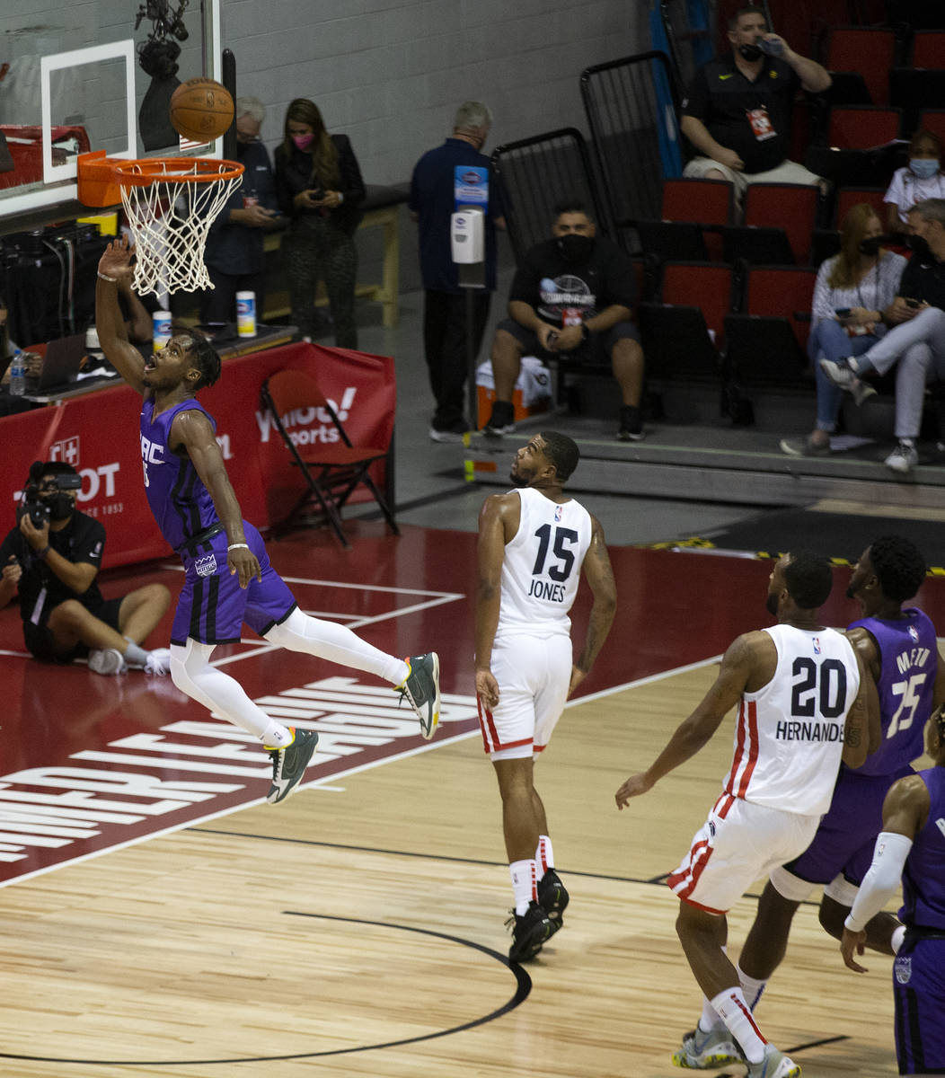 Sacramento Kings guard Davion Mitchell (15) jumps for a layup during the first half of an NBA S ...