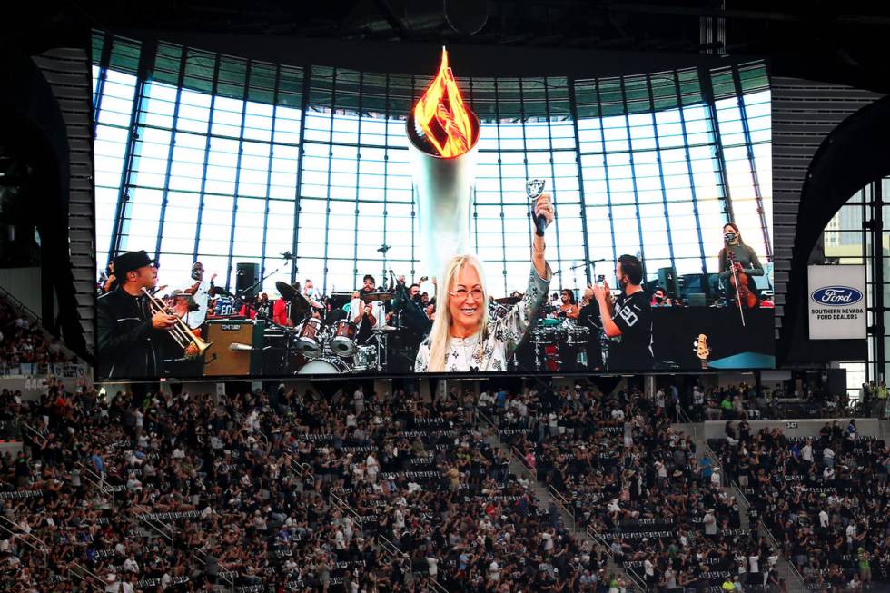 Dr. Miriam Adelson lights the Al Davis Memorial Torch Flame before the starts of a NFL preseaso ...