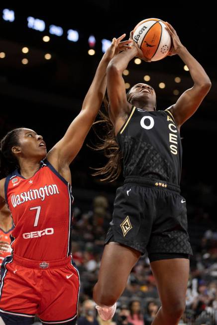 Las Vegas Aces guard Jackie Young (0) is fouled by Washington Mystics guard Ariel Atkins (7) in ...