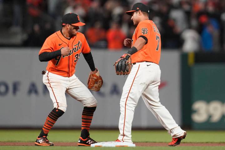 San Francisco Giants' Thairo Estrada, left, and Donovan Solano celebrate after the Giants defea ...