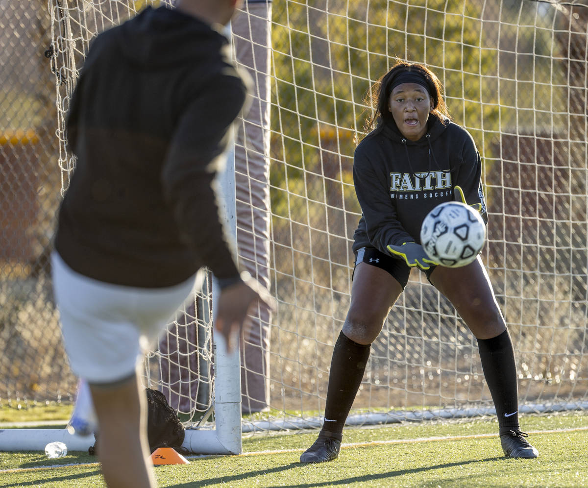 Goalkeeper Jordan Brown defends the net during a girlÕs soccer team practice at Faith Luth ...