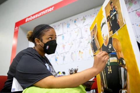 Keely Jackson, a NBA Summer League intern for the third year in a row, does a live painting of ...