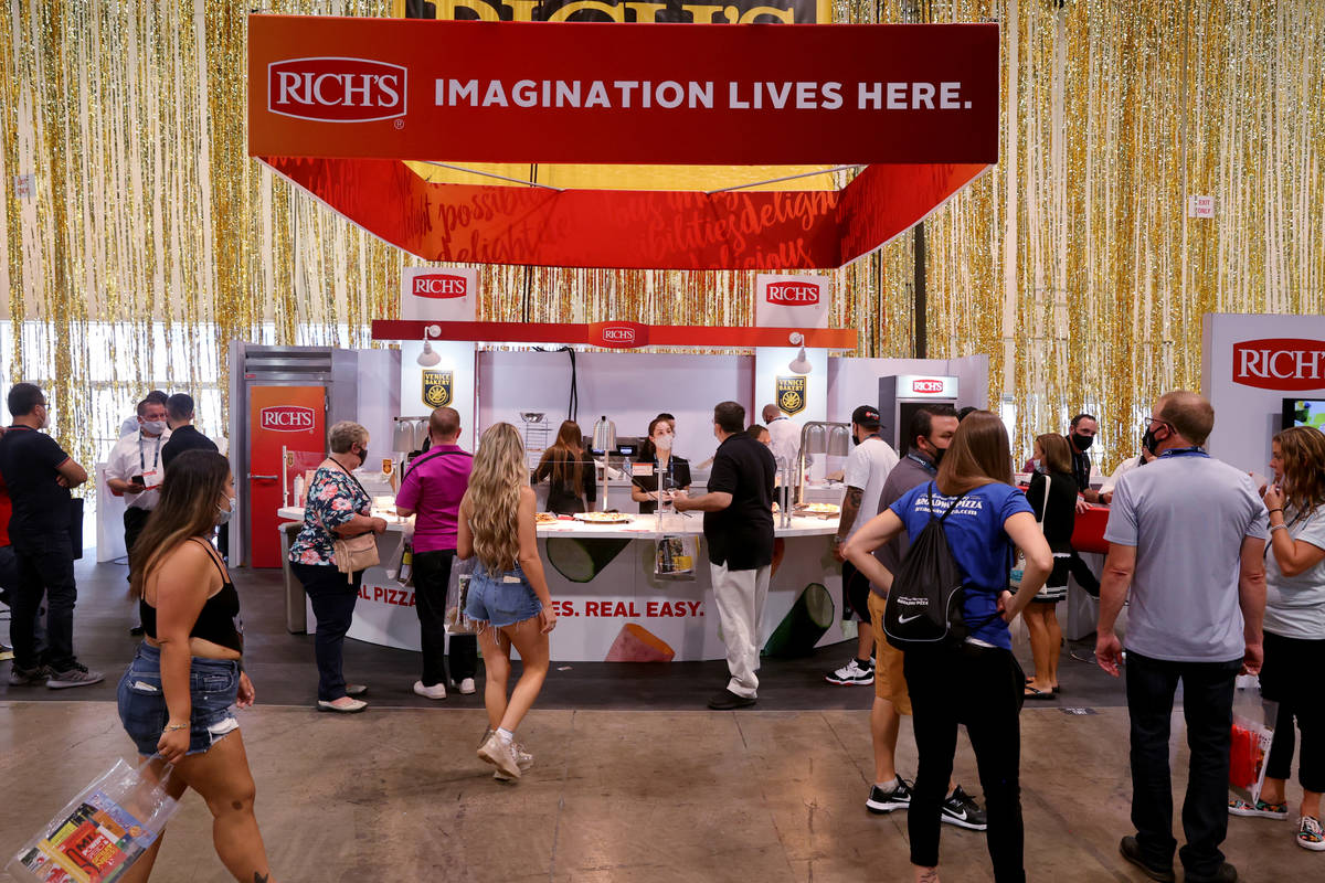 Conventioneers walk on the show floor for the International Pizza Expo at the Las Vegas Convent ...