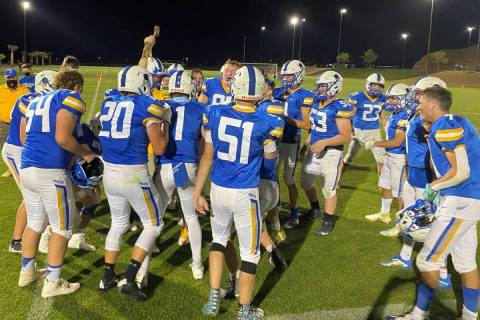Moapa Valley coach Brent Lewis celebrates with the hammer as players circle around after the Pi ...