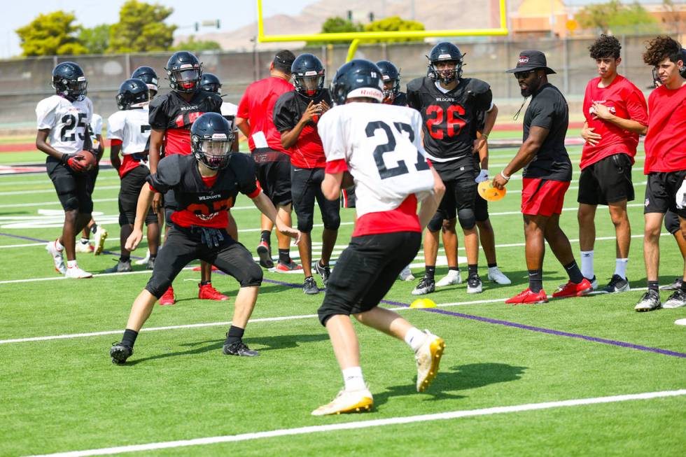 Players practice drills during football practice at Las Vegas High School in Las Vegas, Tuesday ...