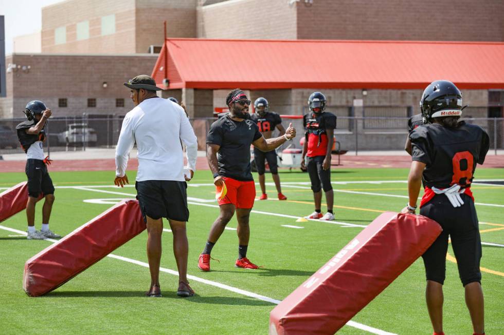 Ronald McCullough, the defensive back coach, addresses players during football practice at Las ...