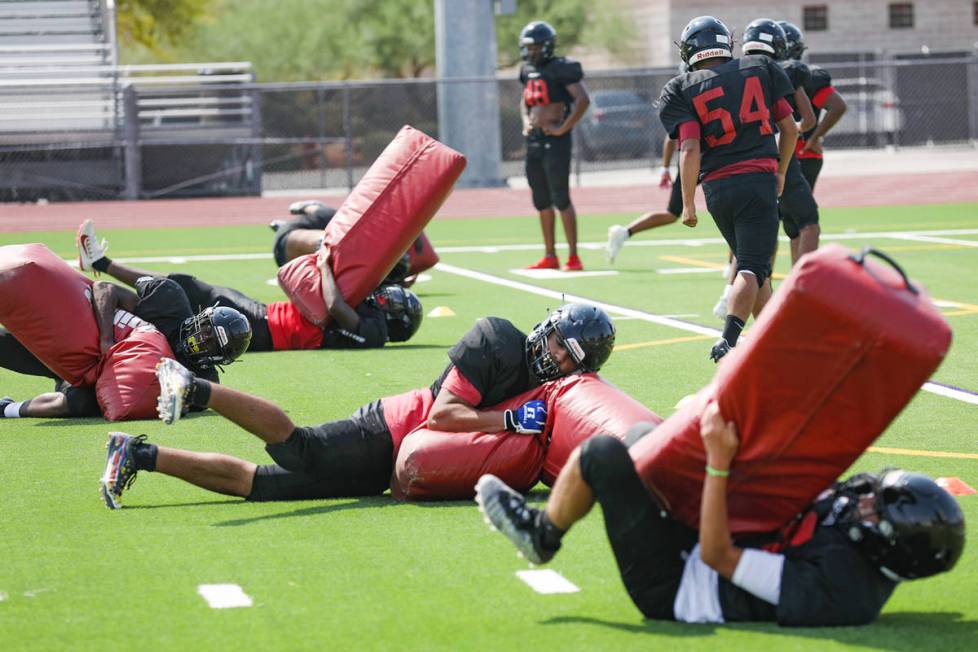 Players practice drills during football practice at Las Vegas High School in Las Vegas, Tuesday ...