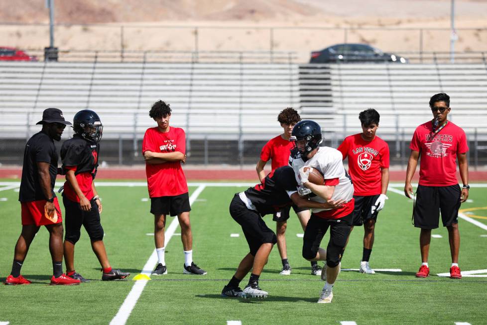 Players practice drills during football practice at Las Vegas High School in Las Vegas, Tuesday ...