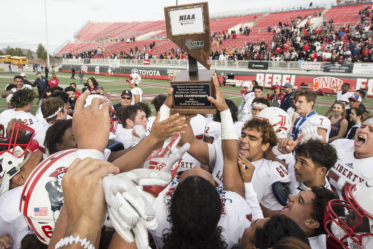 Liberty players celebrate after defeating Centennial 50-7 to win the Class 4A state football ch ...