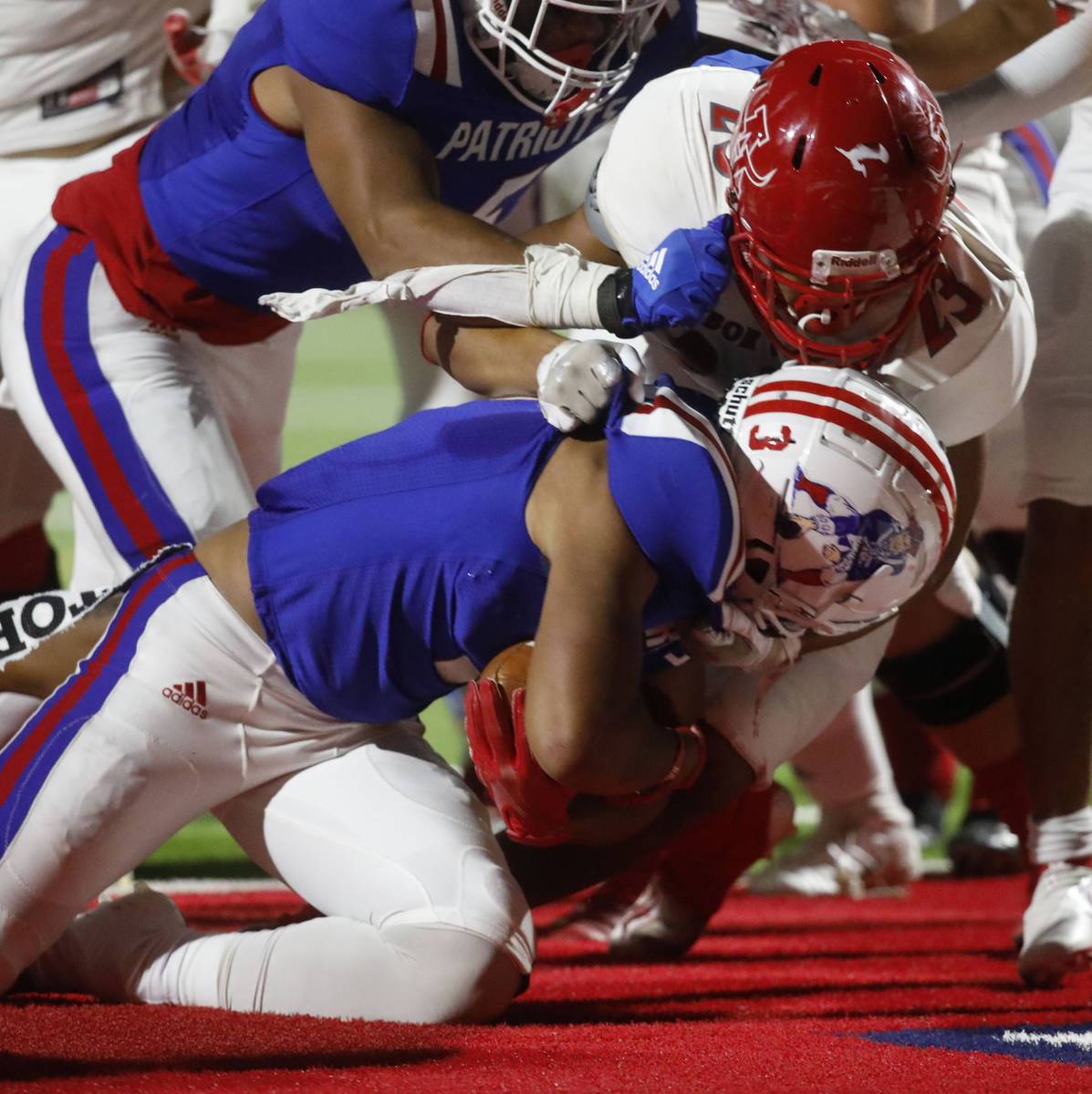 Liberty High School's Larry Royal scores a touchdown over Arbor View High School's Talavoutuput ...